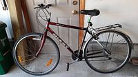 Side view of red Giant Option bicycle showing frame and overall condition.
