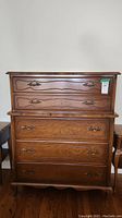 Full front view of five drawer Gibbard dresser showing wood grain and brass handles.