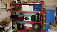 Full view of red Snap-on shelving loaded with miscellaneous items