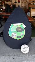 Carrying case of the PUGG 6 foot soccer goal net with attached label showing product information.