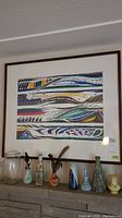 Full view of framed ethnic tribal design print by Keefe with visible frame and surrounding decor.