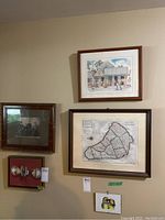 Wall arrangement with four framed items including vintage map, vintage photo, colonial print, and bird print with glass doorknob display below.