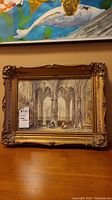 Framed watercolor painting of St Johns Cathedral, Lyons by TE Francis. The frame is ornate and carved with some chips visible. The interior cathedral scene shows gothic architectural details and figures inside.