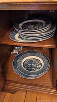 Stack of various sized plates with blue and white scenic pattern, blue Liberty Blue Royal Ironstone dinnerware