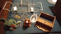 All items shown on a blue textured fabric including various bath accessories on a table surface.