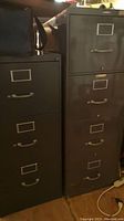 Two vertical metal filing cabinets side by side in a room, showing size and structure
