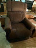 Front view of the brown fabric La-Z-Boy recliner chair showing cushioned armrests, seat and backrest.