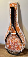 Wilson Ncode N6 tennis racquet with black grip and included soft case with orange and white floral pattern.