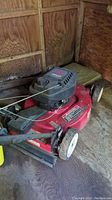 Full side and top view of Toro Recycler lawn mower showing engine cover, fuel cap, wheels and handle.