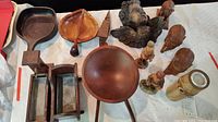 Overview of various miniature wooden items including bowls, figurines, and decorative pieces arranged on a table.