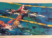Close-up of the swimmers in action showing the colorful water and swimmer details.