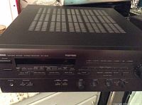Front view of black Yamaha stereo receiver model RX-V570 showing power button, tuning buttons, and volume knob.