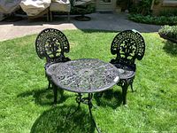 Full overview of two chairs and round table on grass