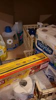 Photo of paper products including Royale toilet paper and paper towels and a box of cling wrap