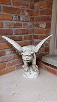 Front left angled view of plaster gargoyle planter showing full wingspan and detailed face.
