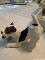 Side view of Royal Doulton ceramic dog figurine showing color and pose