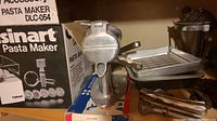 Cuisinart pasta maker with multiple discs and original packaging visible.
