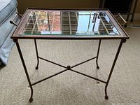 Full view of metal frame tray table with beveled glass insert and X stretcher base.