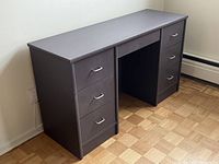 Side angle view showing six drawers with metal handles and paint rubbed spots on edges