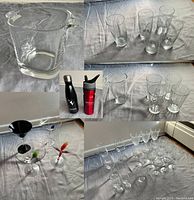 Group image showing heavy glass ice bucket, set of five large water glasses, five small water glasses, two metal reusable water bottles, four martini glasses with colored stems, and an array of wine glasses.