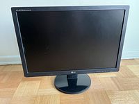 Front view of LG Flatron W2242TQT 22 inch monitor showing black bezel and scratches on screen.