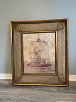 Full view of framed birdcage print showing the artwork and ornate frame.