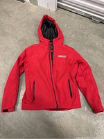 Front view of red Nintendo Switch jacket showing front zipper, hood, zippered pockets, and Nintendo Switch logo on chest.