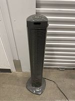 Full view of Seville Classics gray tower fan showing vertical grille and stable base with power cord.