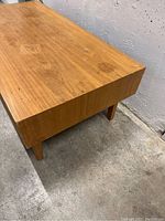 Corner view showing wood grain and surface wear near edge