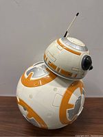 Front view of the BB-8 rounded body with orange and gray detailing and spherical head with antenna.