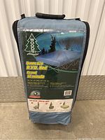 Blue carrying bag with product label showing Woods queen size B.Y.O. Bed model details and setup instructions.