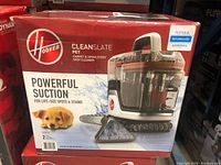 Box of Hoover Cleanslate Pet spot cleaner showing product name, image of the cleaner, and claim for powerful suction for large spots and stains, with pet image on packaging.