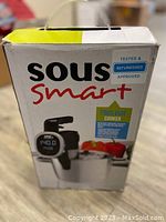 Front view of the SousSmart sous vide cooker box indicating refurbished and tested approval.