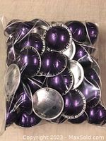 Photo showing a clear plastic bag filled with 50 purple metallic Nespresso Altissio coffee pods.