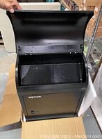 Front view of opened black VEVOR mailbox showing interior and locking door.