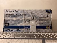 Original boxed Glacier Bay 600 Series Bathroom Faucet with one handle and pop-up drain, chrome finish