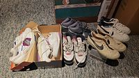 Lot of seven pairs of shoes including Nike and Reebok in various colors and styles, some in boxes.