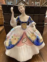 Front view of Royal Doulton Christine figurine showing the detailed floral dress, facial features, and necklace.