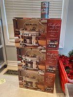 Three boxed oval chafing dishes stacked with two methanol gel fuel cans on top