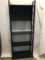 Full front view of the dark brown wooden book shelf showing all 5 shelves.