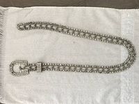 Full view of the rhinestone belt laid out flat, showing entire length and buckle.