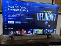 Front view of LG flat screen smart TV showing NFL Draft content on screen