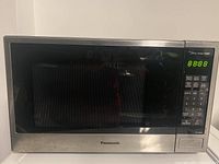Panasonic stainless steel microwave with black front and digital control panel on side