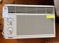 Front view of Kenmore air conditioner showing full front grille and control knobs, with a yellow note showing dimensions 16x16x19.