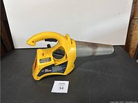 Side view of the yellow Black Flag Bug Fogger showing handle, nozzle, and control dial.