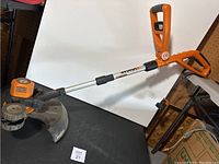 Full view of the WORX electric weed wacker showing the full shaft, handle, and trimming head