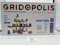 Front box image showing full box cover with image of game pieces stacked in a 3D grid structure. Includes logos, game details, player count, and game duration.