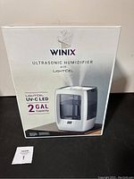 Photo of front of the product box showing branding, product image, and key features with title.