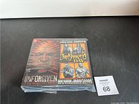 Photo showing both VHS tapes in plastic wrap. Left tape titled 'Unforgiven' with fiery warrior face design and date September 21, 2003. Right tape titled 'Judgment Day' featuring wrestlers Kevin Nash, Triple H, Big Show, and Brock Lesnar.
