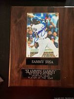 Full view of the autographed Sammy Sosa plaque mounted on wood with engraved plates.